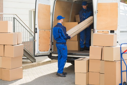 Man and van team safely loading furniture into a vehicle