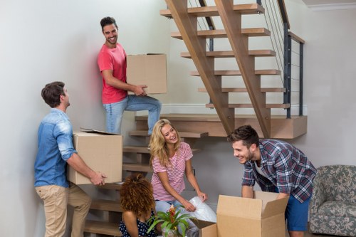 Removal team planning a flat move in Uxbridge with boxes and furniture