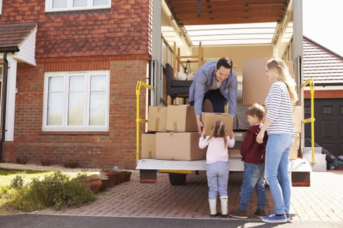 Removal team loading household furniture in Uxbridge