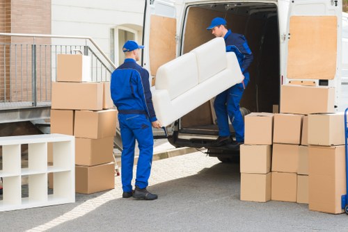 Professional piano movers loading an instrument for transport from a Uxbridge home
