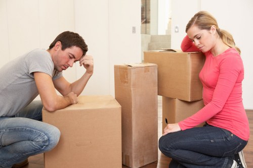 Moving team carrying items down stairs during a flat removal in Uxbridge